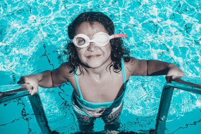 Portrait of smiling young woman in swimming pool