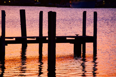 Pier over lake during sunset