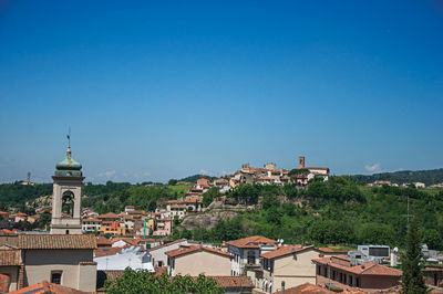 Bell tower and buildings on top of the hill in the center of montelupo fiorentino, italy.