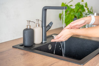 Cropped hand of woman holding equipment