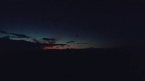 Scenic view of landscape against sky at night