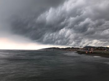 Scenic view of sea against storm clouds