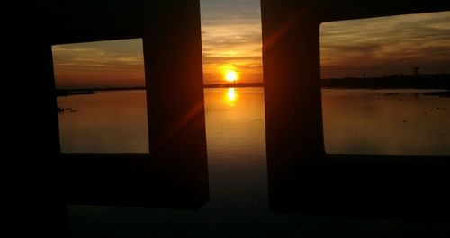 Scenic view of sunset seen through window