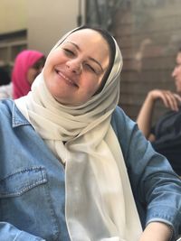 Close-up portrait of smiling young woman standing outdoors