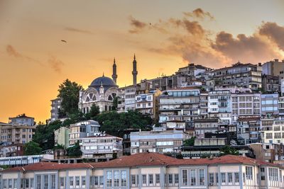 Buildings in city at sunset