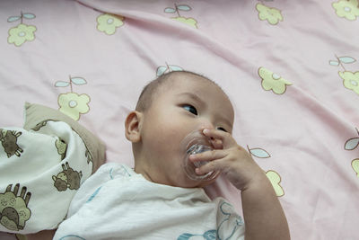 Cute baby lying on bed