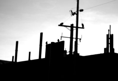 Low angle view of silhouette building against sky