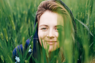 Portrait of smiling young woman on field