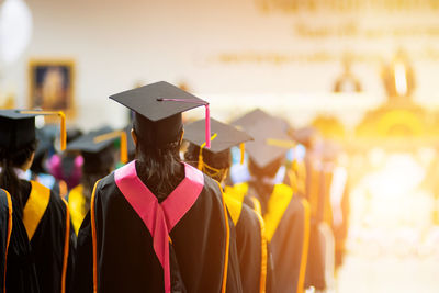 Rear view of students wearing mortarboards during graduation