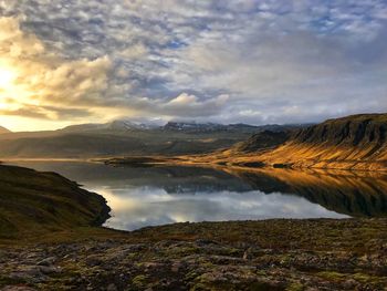 Scenic view of mountains against cloudy sky