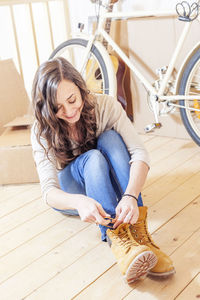 High angle view of young woman sitting on floor at home