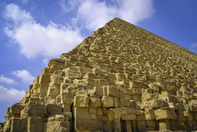 Low angle view of old ruin building against cloudy sky