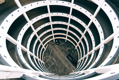 From above of spiral shaped car parking with curved lines located in hamburg