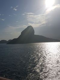 Scenic view of sea and mountains against sky