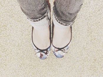 Low section of woman standing on tiled floor