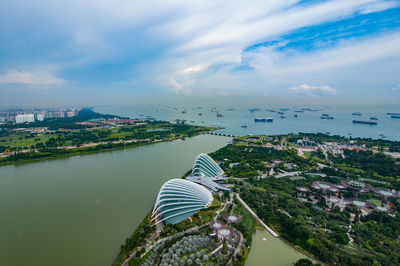 High angle view of river amidst city against sky