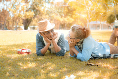 Rear view of women sitting on grass