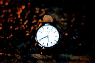 Close-up of clock against black background