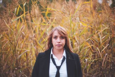 Businesswoman standing in forest