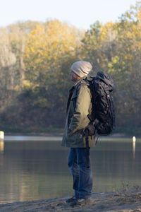 Portrait of traveler man at lake in autumn