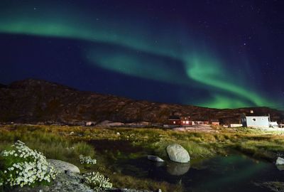 Scenic view of illuminated buildings against sky at night