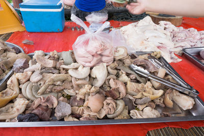 Cropped image of person holding meat at table