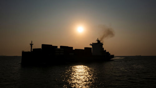 Silhouette container ship full load carrying for import and export, business cargo logistic 