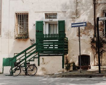 Bicycle parked against building