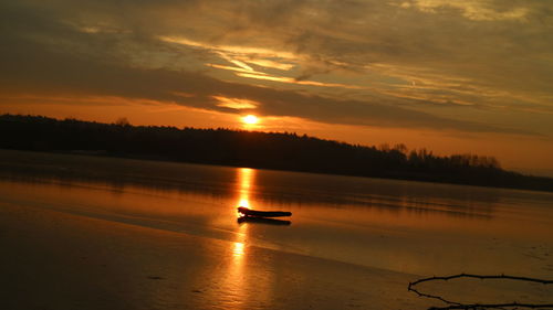 Scenic view of lake against sky during sunset