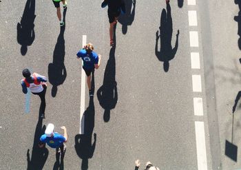 High angle view of athletes running on street during marathon