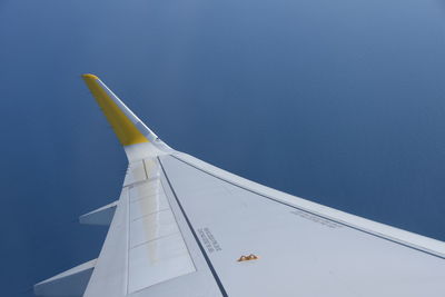 Cropped image of airplane against clear sky