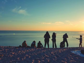 Silhouettes of people viewing sunset over lake michigan from sleeping bear dunes