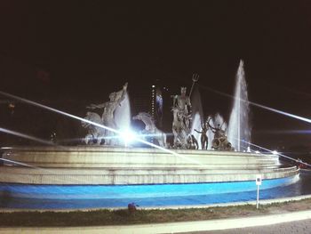 Light trails by swimming pool at night