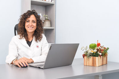 Young woman using laptop at table