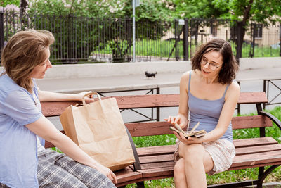 Young woman smiling while sitting on bench