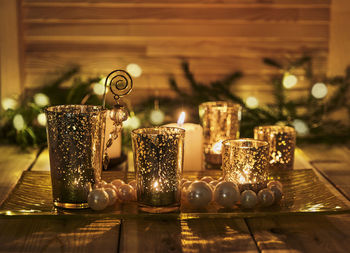 Close-up of illuminated candles on table