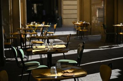 Empty chairs and tables in restaurant terrace