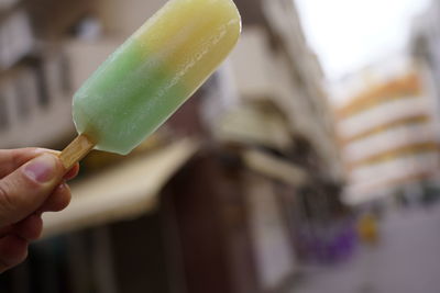 Close-up of hand holding ice cream cone