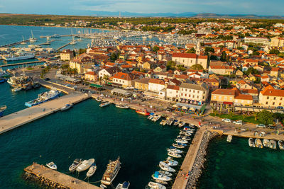 High angle view of townscape by sea against sky