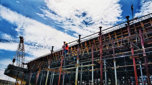 Low angle view of construction site against sky