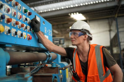 Rear view of man working in factory