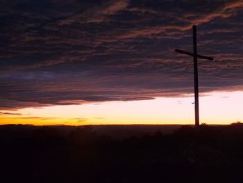 Scenic view of silhouette landscape against dramatic sky during sunset