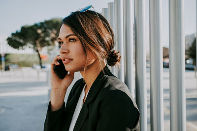 Portrait of young woman using mobile phone