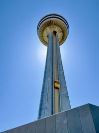 Low angle view of skyscraper against clear blue sky