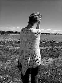 Rear view of woman standing on field