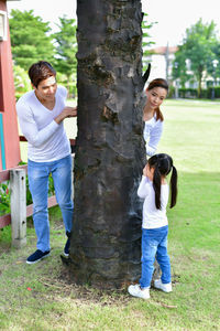 Family playing hide and seek at park