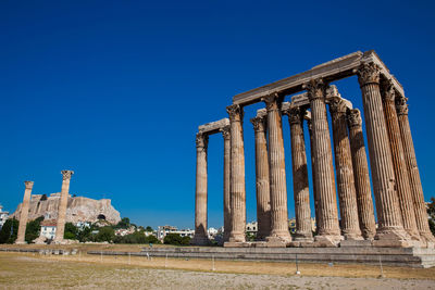 Ruins of the temple of olympian zeus also known as the olympieion and the acropolis in athens 