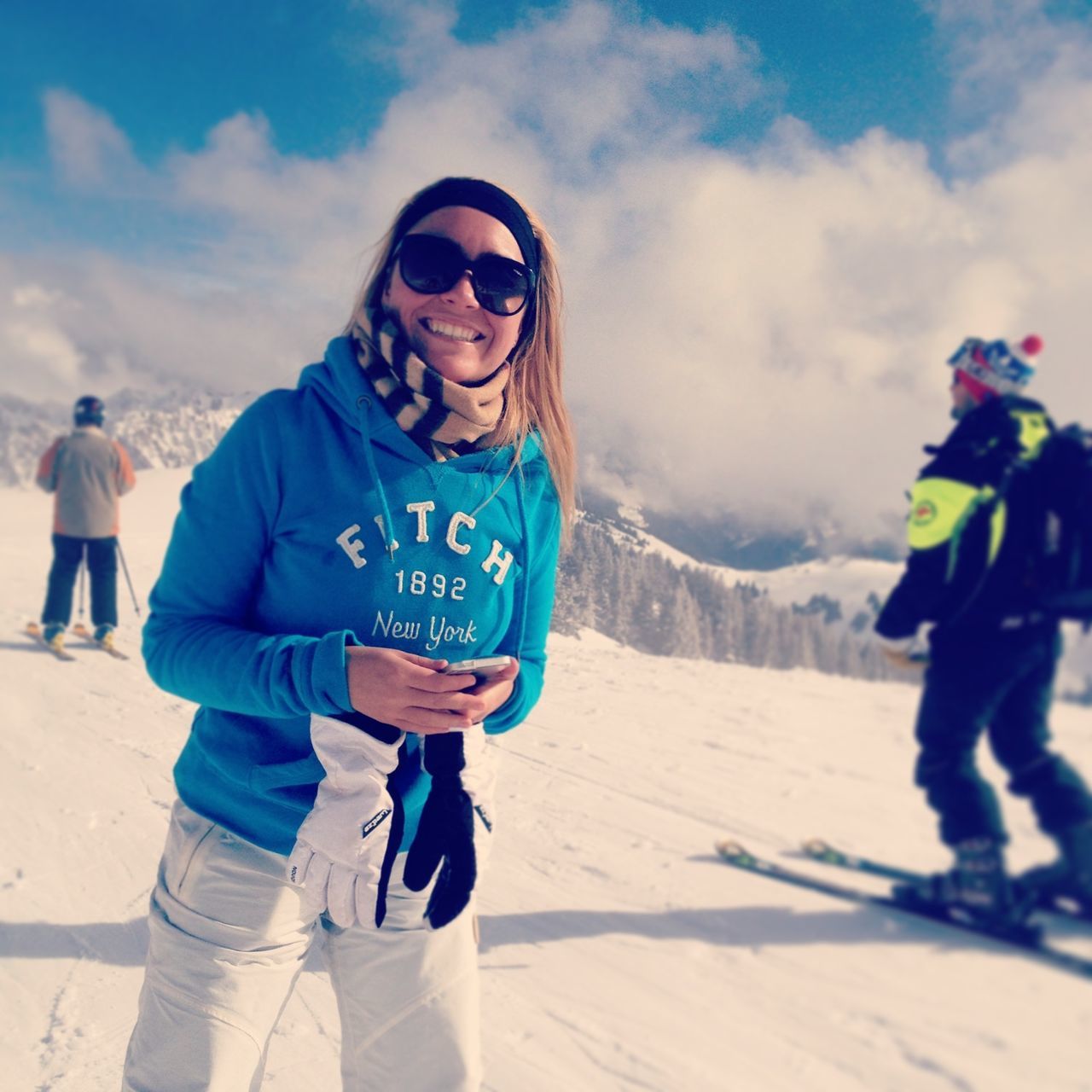 leisure activity, lifestyles, snow, winter, cold temperature, person, casual clothing, full length, sky, looking at camera, front view, warm clothing, vacations, portrait, mountain, happiness, smiling, sunlight