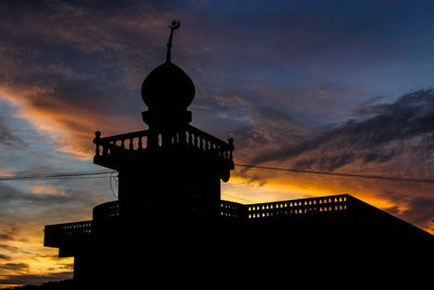 Low angle view of silhouette mosque against sky during sunset