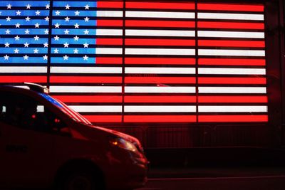 Close-up of car against illuminated flag